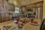 Quaint kitchen with beautifully stained cabinets